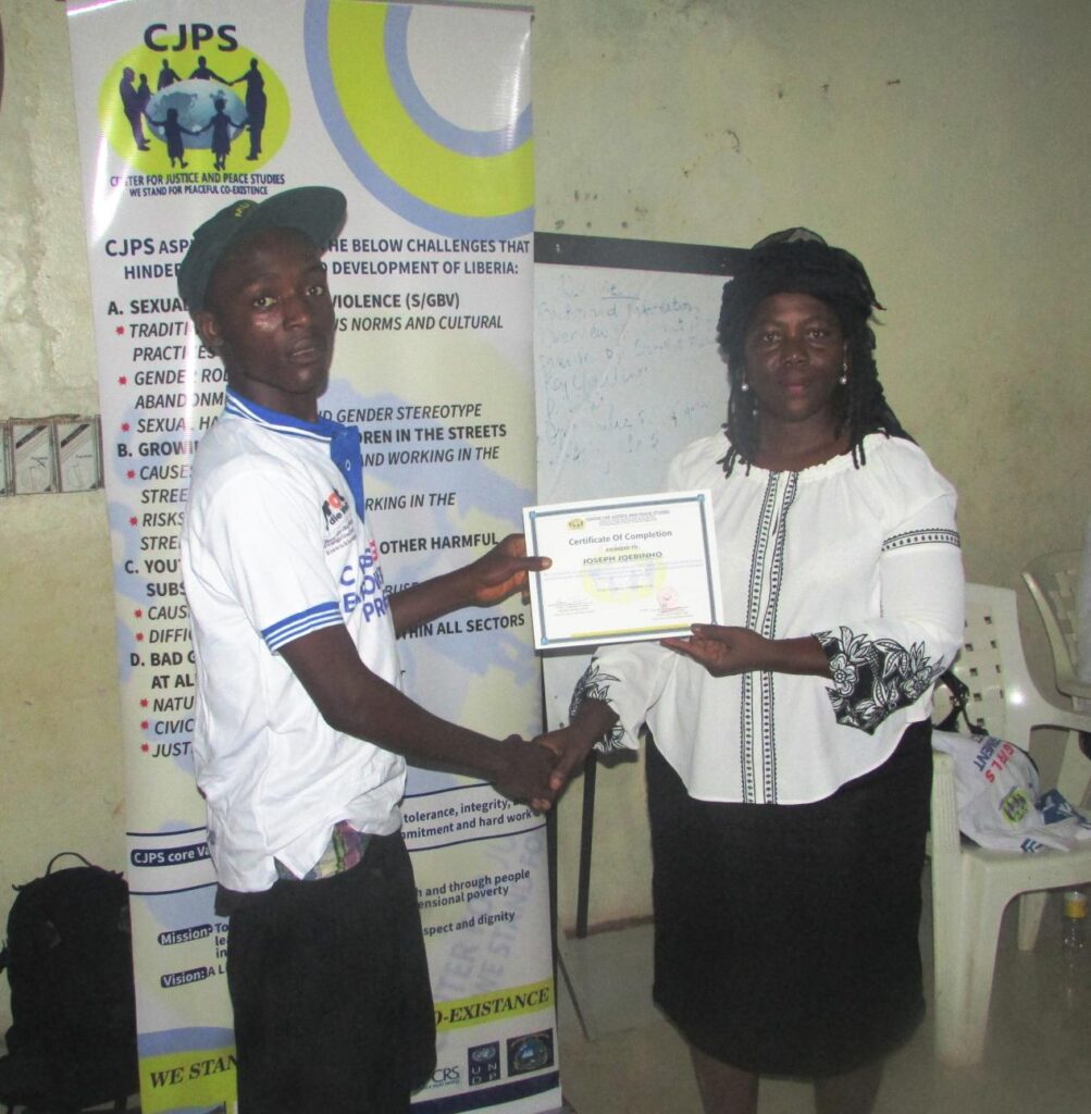A trainee receives his certificate from Mrs. Asilton (2)