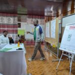 A person standing in front of a whiteboard
AI-generated content may be incorrect.